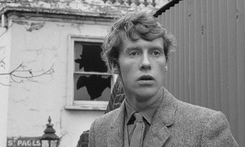 Movie still from “The Knack... and How to Get It” (1965), directed by Richard Lester – A man in a suit and tie standing in front of a window; Close Up shot, Low angle