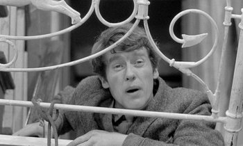 Movie still from “The Knack... and How to Get It” (1965), directed by Richard Lester – A black - and - white photo of a man in a bed; Close Up shot, High angle