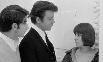 A black and white photo of a man and two women