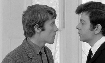 Movie still from “The Knack... and How to Get It” (1965), directed by Richard Lester – Two men are facing each other in front of a window; Close Up shot, Over the shoulder angle