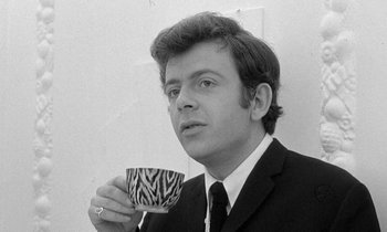Movie still from “The Knack... and How to Get It” (1965), directed by Richard Lester – A man in a suit holding a coffee cup; Close Up shot, Low angle