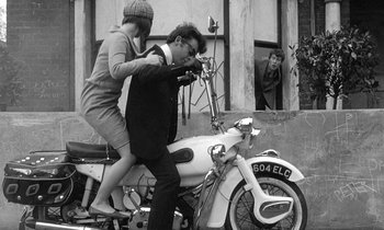 Movie still from “The Knack... and How to Get It” (1965), directed by Richard Lester – A man and a woman riding a motorcycle; Wide shot, High angle