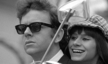 Movie still from “The Knack... and How to Get It” (1965), directed by Richard Lester – A black and white photo of a man and a woman with an umbrella; Close Up shot, Low angle