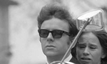 Movie still from “The Knack... and How to Get It” (1965), directed by Richard Lester – A black and white photo of a man wearing sunglasses; Close Up shot, Low angle
