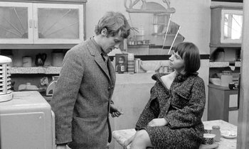 Movie still from “The Knack... and How to Get It” (1965), directed by Richard Lester – A man and a woman standing next to each other in a room; Medium shot, Over the shoulder angle