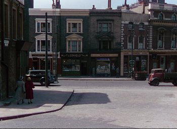 Movie still from “The Ladykillers” (1955), directed by Alexander Mackendrick – An old photo of an intersection in the middle of a city; Extreme Wide shot, High angle