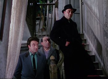 Movie still from “The Ladykillers” (1955), directed by Alexander Mackendrick – A group of men standing next to each other on stairs; Medium shot, Low angle
