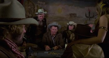 Movie still from “The Last Movie” (1971), directed by Dennis Hopper – A group of men sitting at a table playing cards; Wide shot, Over the shoulder angle