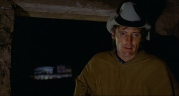 Movie still from “The Last Movie” (1971), directed by Dennis Hopper – A man wearing a cowboy hat in the dark; Close Up shot, Low angle