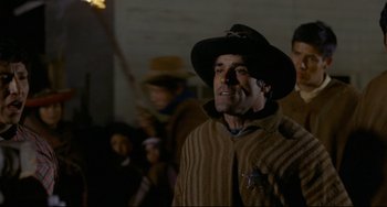 Movie still from “The Last Movie” (1971), directed by Dennis Hopper – A man wearing a cowboy hat and a brown jacket; Medium shot, Low angle