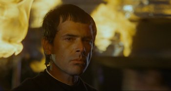 Movie still from “The Last Movie” (1971), directed by Dennis Hopper – A person wearing a black shirt; Close Up shot, Low angle