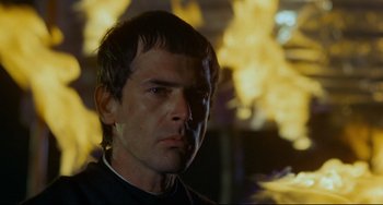 Movie still from “The Last Movie” (1971), directed by Dennis Hopper – A person wearing a black shirt; Close Up shot, Low angle