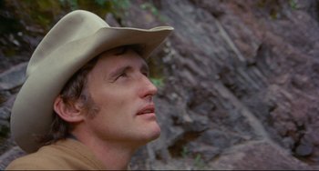 Movie still from “The Last Movie” (1971), directed by Dennis Hopper – A person wearing a cowboy hat; Close Up shot, Low angle