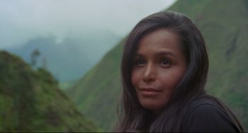 Movie still from “The Last Movie” (1971), directed by Dennis Hopper – A person with long black hair; Close Up shot, High angle