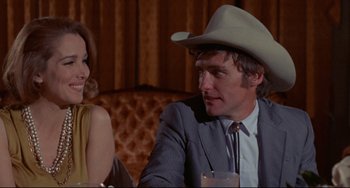 Movie still from “The Last Movie” (1971), directed by Dennis Hopper – A man and a woman sitting at a dinner table; Medium shot, Low angle