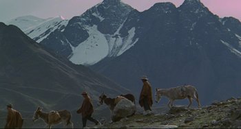 Movie still from “The Last Movie” (1971), directed by Dennis Hopper – A group of people walking on top of a mountain; Wide shot, High angle