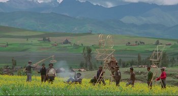 Movie still from “The Last Movie” (1971), directed by Dennis Hopper – A group of people standing in the middle of a field; Extreme Wide shot, High angle