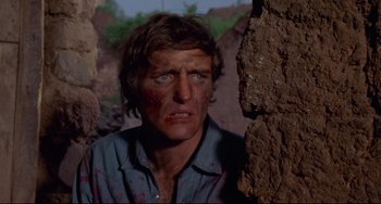 Movie still from “The Last Movie” (1971), directed by Dennis Hopper – A person near a wall; Close Up shot, Low angle