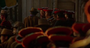 Movie still from “The Last Movie” (1971), directed by Dennis Hopper – A group of people wearing red hats in front of a crowd; Medium shot, High angle