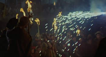 Movie still from “The Last Movie” (1971), directed by Dennis Hopper – A group of people are gathered in the dark; Wide shot, High angle