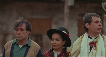 Movie still from “The Last Movie” (1971), directed by Dennis Hopper – A group of people standing next to each other on a street; Medium shot, Low angle