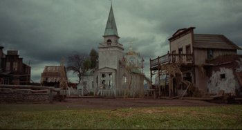 Movie still from “The Last Movie” (1971), directed by Dennis Hopper – An old church with steeple and steeple in the background; Extreme Wide shot, Low angle