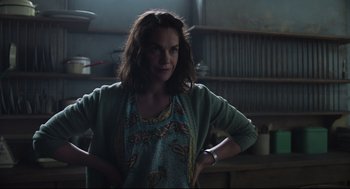 Movie still from “The Little Stranger” (2018), directed by Lenny Abrahamson – A woman standing in a room with her hands on her hips; Medium shot, Low angle