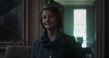 Movie still from “The Little Stranger” (2018), directed by Lenny Abrahamson – An older woman wearing a gray coat and a brooch; Close Up shot, Low angle