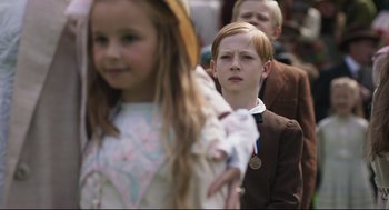 Movie still from “The Little Stranger” (2018), directed by Lenny Abrahamson – A boy and a little girl are standing in a line; Close Up shot, High angle