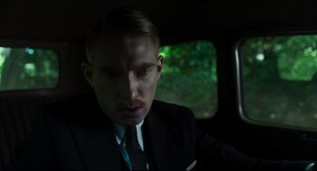 Movie still from “The Little Stranger” (2018), directed by Lenny Abrahamson – A man in a suit and tie sitting in a car; Close Up shot, Low angle