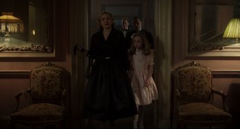 Movie still from “The Little Stranger” (2018), directed by Lenny Abrahamson – A group of people standing in a room; Medium shot, Low angle