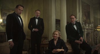 Movie still from “The Little Stranger” (2018), directed by Lenny Abrahamson – A group of people standing in front of a wall; Medium shot, Low angle