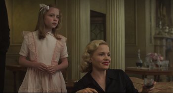 Movie still from “The Little Stranger” (2018), directed by Lenny Abrahamson – A woman and a little girl sitting in front of a table; Medium shot, Over the shoulder angle