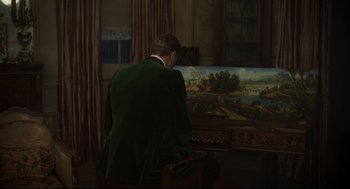 Movie still from “The Little Stranger” (2018), directed by Lenny Abrahamson – A man sitting in front of a painting; Wide shot, Over the shoulder angle
