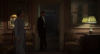 Movie still from “The Little Stranger” (2018), directed by Lenny Abrahamson – A man in a suit standing in a room; Wide shot, Low angle