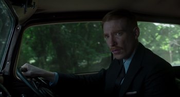 Movie still from “The Little Stranger” (2018), directed by Lenny Abrahamson – A man sitting in the drivers seat of a car; Close Up shot, Low angle
