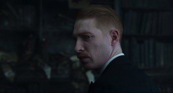 Movie still from “The Little Stranger” (2018), directed by Lenny Abrahamson – A person wearing a suit and tie; Close Up shot, Over the shoulder angle