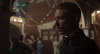 Movie still from “The Little Stranger” (2018), directed by Lenny Abrahamson – A person wearing a suit and tie; Close Up shot, Over the shoulder angle