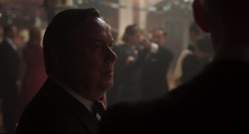 Movie still from “The Little Stranger” (2018), directed by Lenny Abrahamson – A man in a suit and a tie; Close Up shot, Over the shoulder angle
