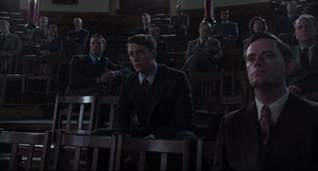 Movie still from “The Little Stranger” (2018), directed by Lenny Abrahamson – A group of men in suits and ties sitting in a courtroom; Medium shot, Low angle