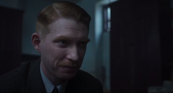 Movie still from “The Little Stranger” (2018), directed by Lenny Abrahamson – A person wearing a suit and tie; Close Up shot, Over the shoulder angle