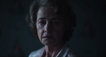 Movie still from “The Little Stranger” (2018), directed by Lenny Abrahamson – An older woman is looking at the camera; Close Up shot, Low angle