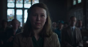 Movie still from “The Little Stranger” (2018), directed by Lenny Abrahamson – A woman in a green shirt and brown jacket; Close Up shot, Over the shoulder angle