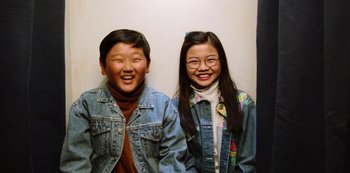 Movie still from “Always Be My Maybe” (2019), directed by Nahnatchka Khan – A couple of people standing next to each other on a wall; Medium shot, Overhead angle