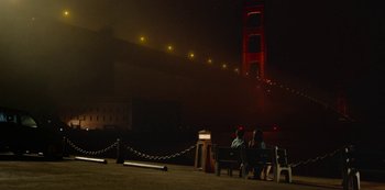 Movie still from “Always Be My Maybe” (2019), directed by Nahnatchka Khan – Two people sitting on a bench in front of the golden gate bridge at night; Extreme Wide shot, Low angle
