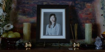 Movie still from “Always Be My Maybe” (2019), directed by Nahnatchka Khan – A picture of a young woman is displayed on a table; Extreme Close Up shot, Low angle