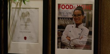 Movie still from “Always Be My Maybe” (2019), directed by Nahnatchka Khan – A magazine cover of a woman in a chef's outfit; Extreme Close Up shot, Over the shoulder angle