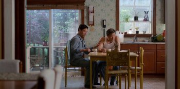 Movie still from “Always Be My Maybe” (2019), directed by Nahnatchka Khan – A man and a woman sitting at a dining table; Medium shot, Over the shoulder angle