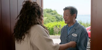 Movie still from “Always Be My Maybe” (2019), directed by Nahnatchka Khan – An older man and a younger woman shaking hands; Medium shot, Over the shoulder angle