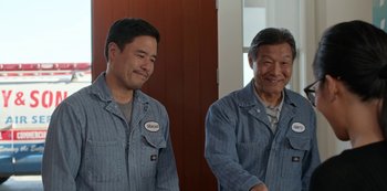 Movie still from “Always Be My Maybe” (2019), directed by Nahnatchka Khan – Two men standing next to each other smiling; Medium shot, Over the shoulder angle